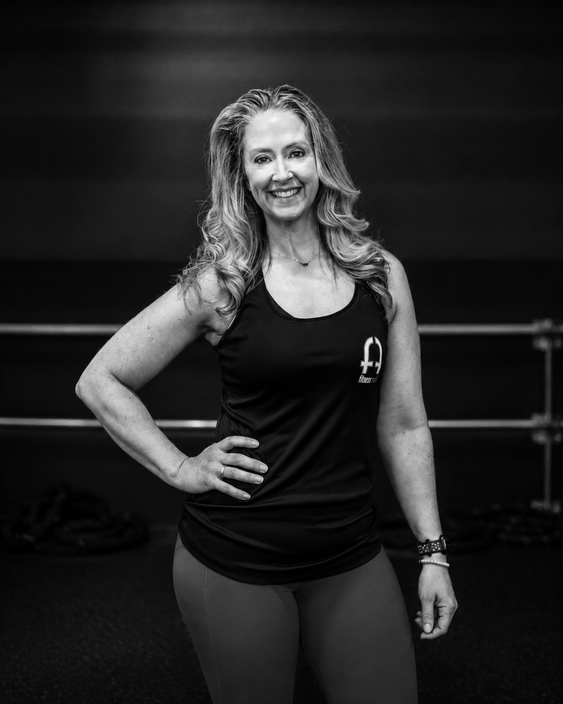 Heather Brown smiling inside the Fitness Artist training space