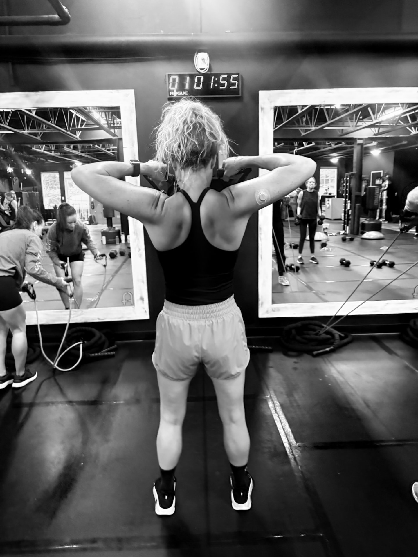 A member focused on her own training in the Fitness Artist space