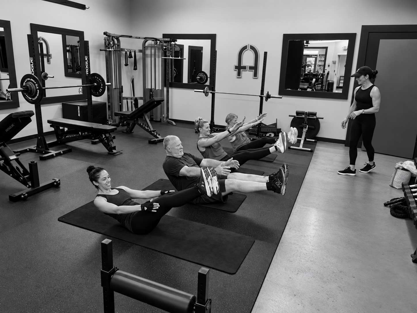 Coach making a form correction during a small-group session
