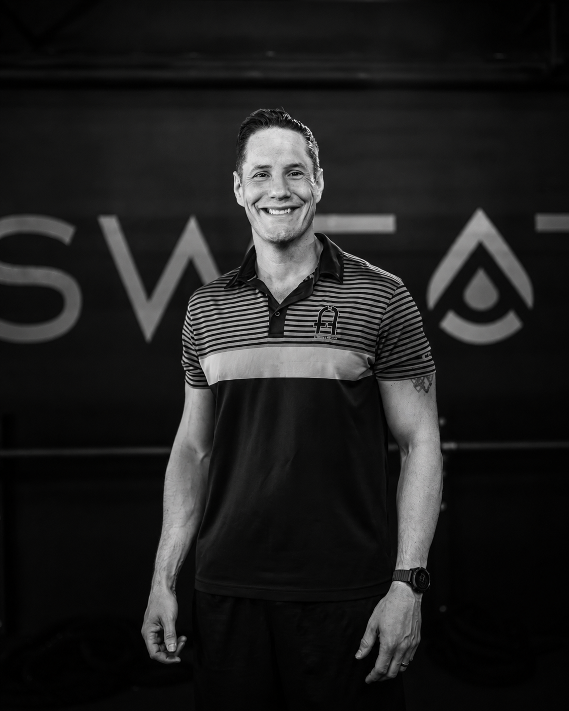 Travis Gil smiling inside the Fitness Artist training space
