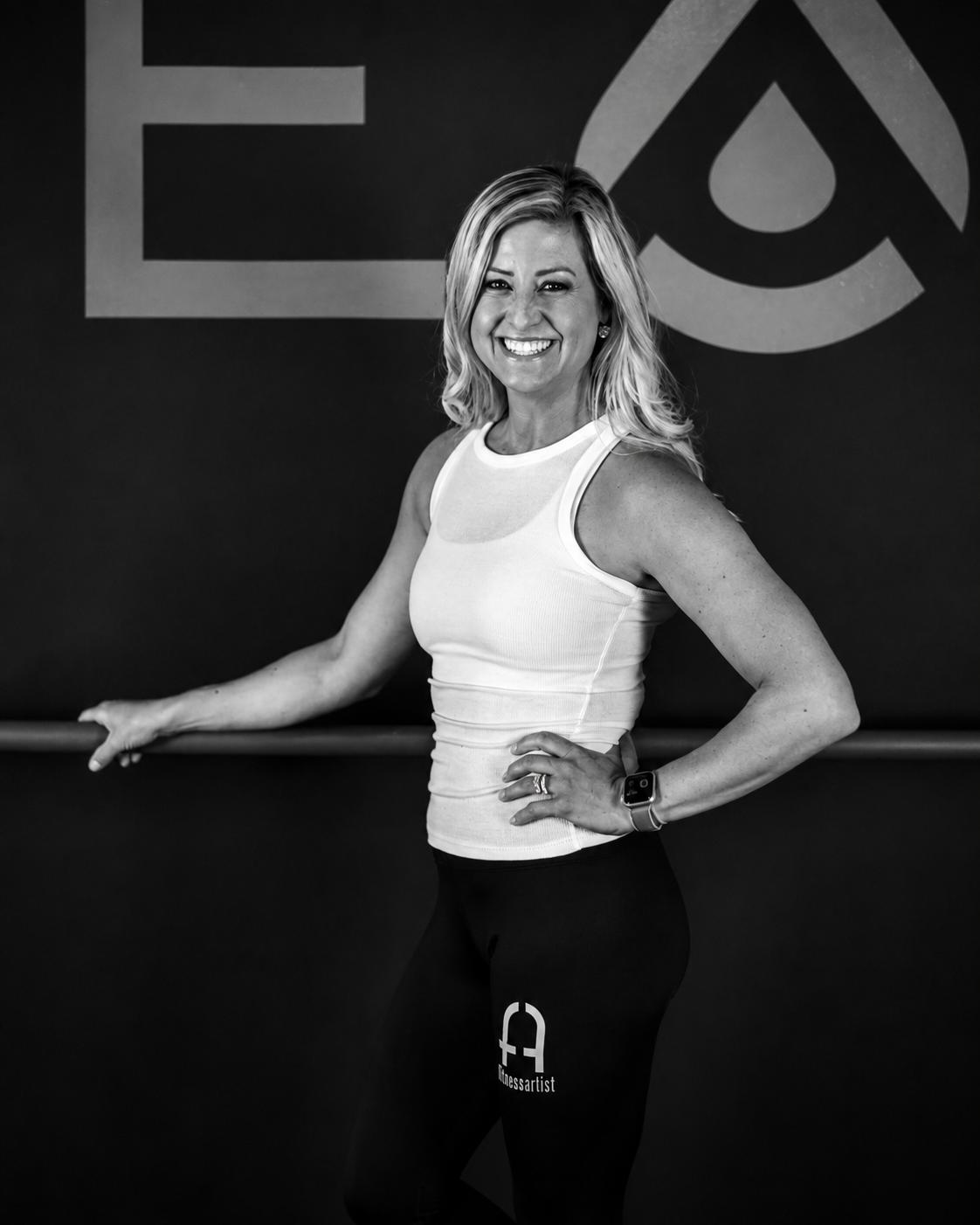 Kristen Gil smiling inside the Fitness Artist training space